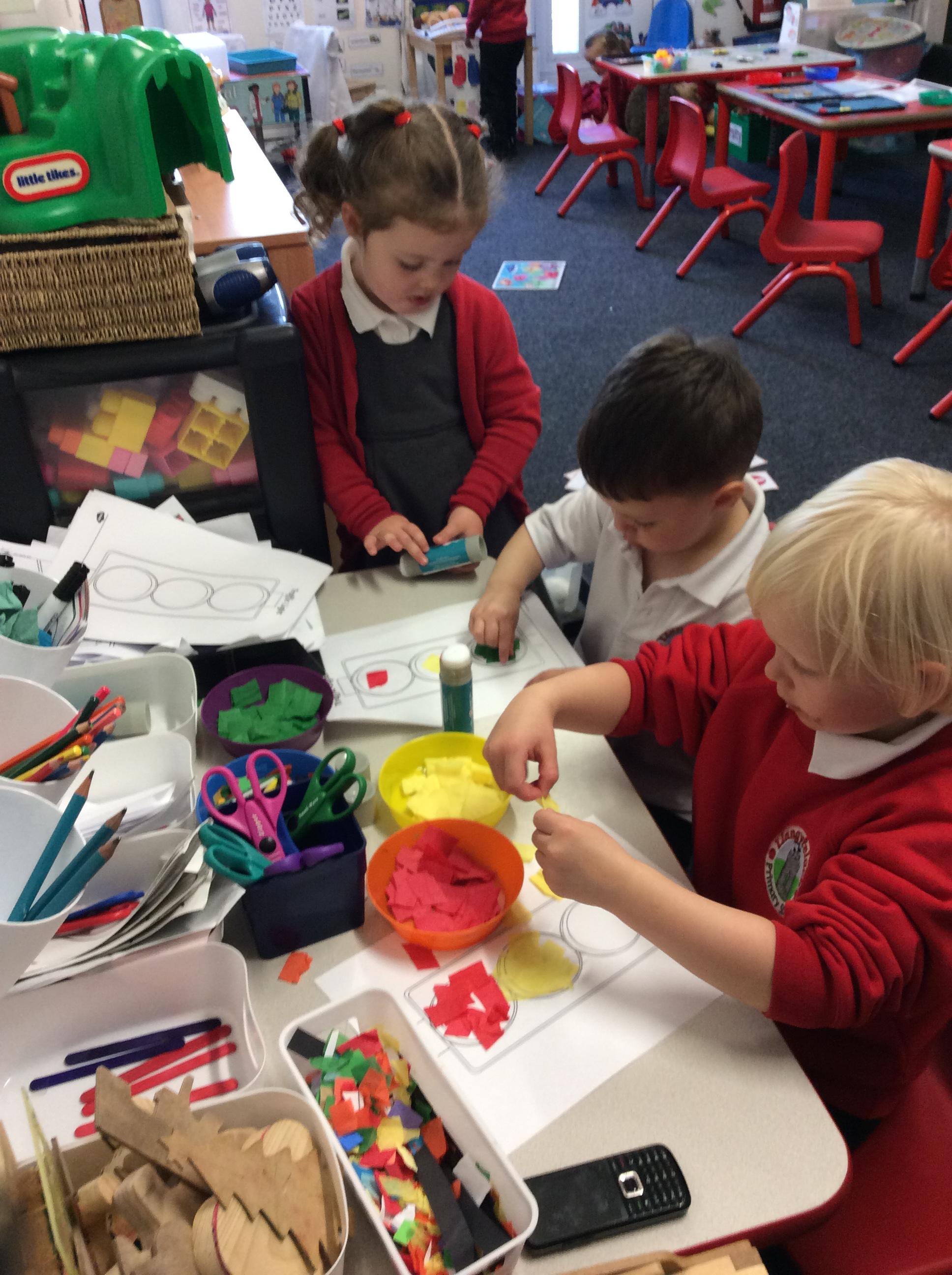 We stuck the right colour tissue paper in order on our traffic light.